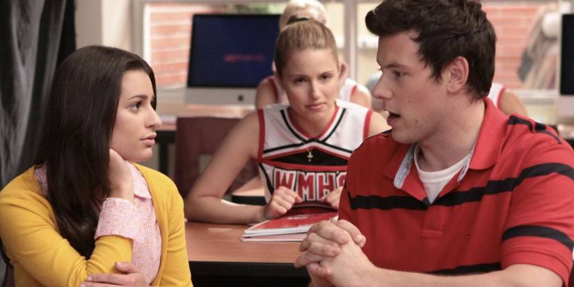 Rachel and Finn talking to one another and Quinn looking at them in Glee