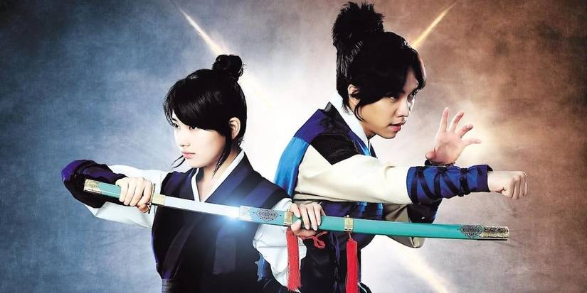 Two of the cast from Gu Family Book pose for a promotional photo with a long sword and action stance.