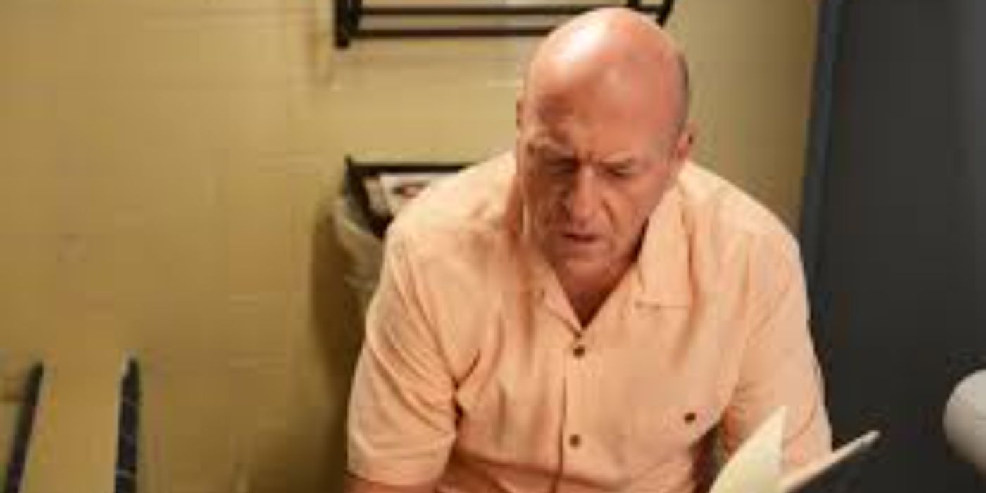 Hank looking down at a book in Breaking Bad