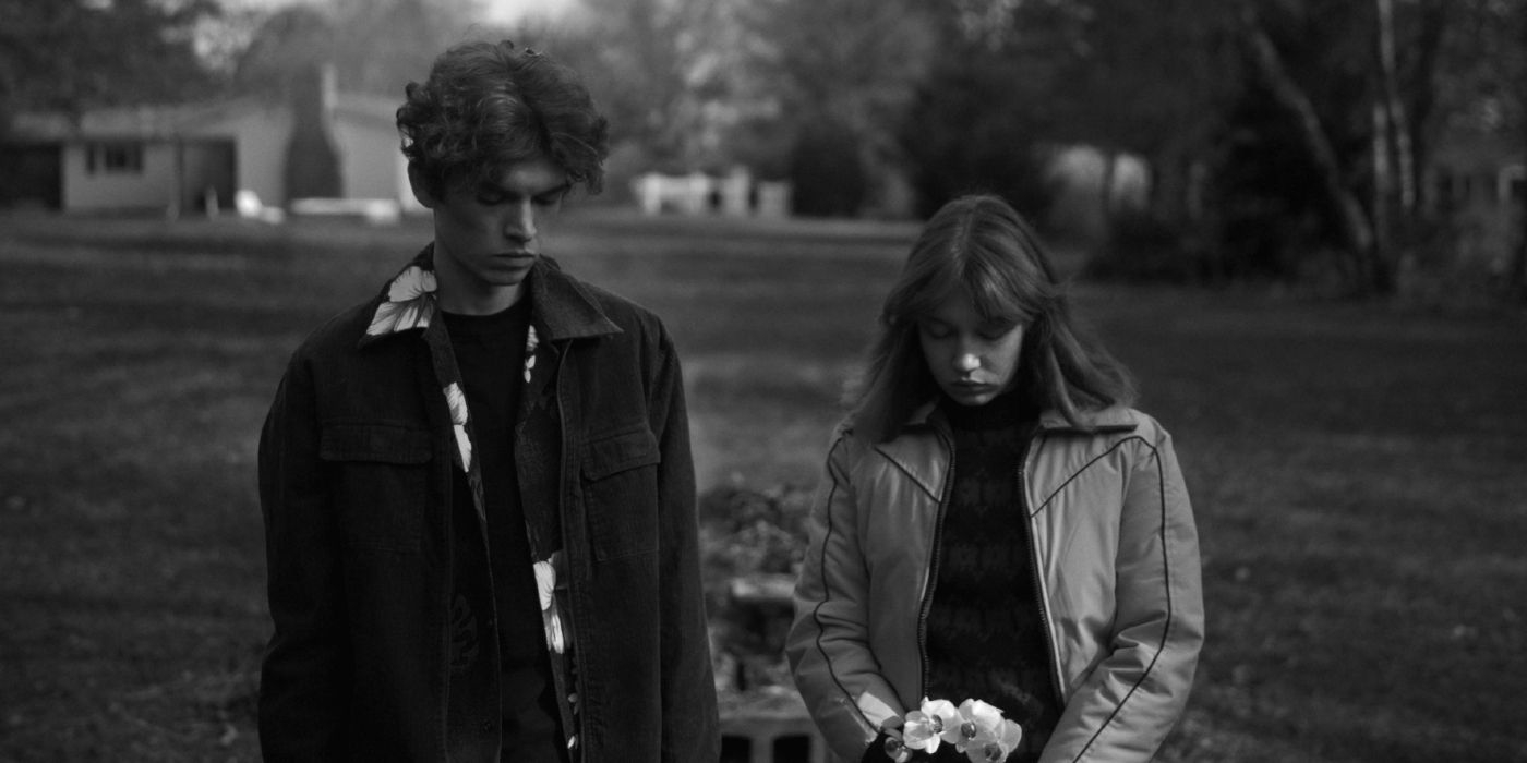 Kimball Farley and Lilla Kizlinger looking down at a grave in Hippo