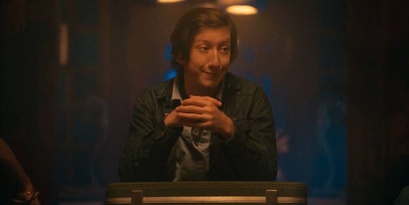 David Thompson as Forbes holding his hands together in It's What's Inside.