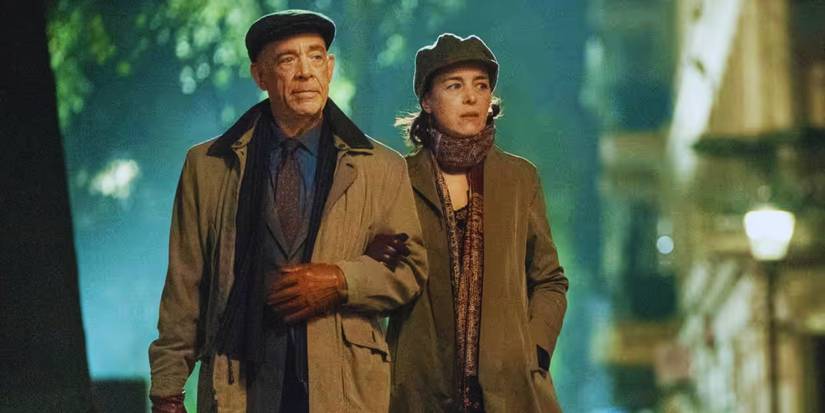JK Simmons and Olivia William walking arm in arm down a street at night in Counterparts.