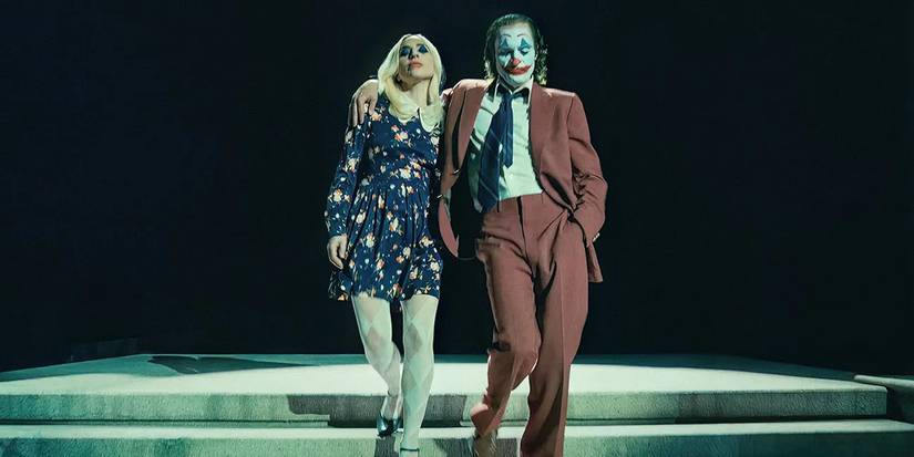 Arthur Fleck, in Joker makeup, and Lee waltz down a set of stairs in 'Joker: Folie à Deux'.