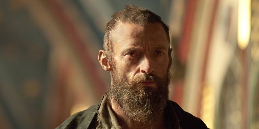 Hugh Jackman as Jean Valjean looking scruffy and staring ahead intently in Les Miserables.