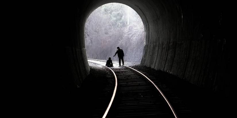 A man aiming a gun at another man at the end of a tunnel in Memories of a Murder