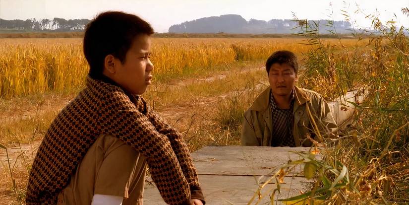 A man and a kid in the fields in Memories of a Murder