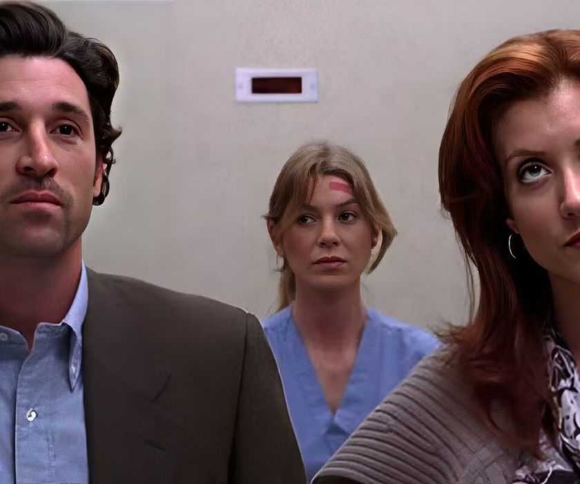 Derek (Patrick Dempsey), Addison (Kate Walsh), and Meredith (Ellen Pompeo) standing awkwardly in an elevator in Grey's Anatomy