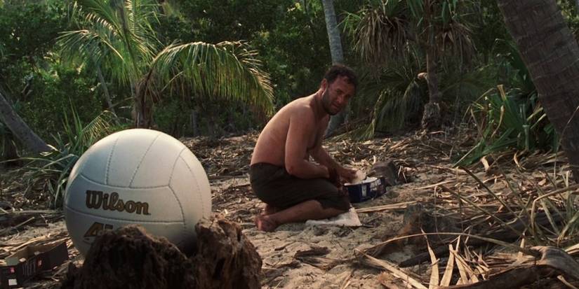 Tom Hanks as Chuck Noland looking at a volleyball in Cast Away