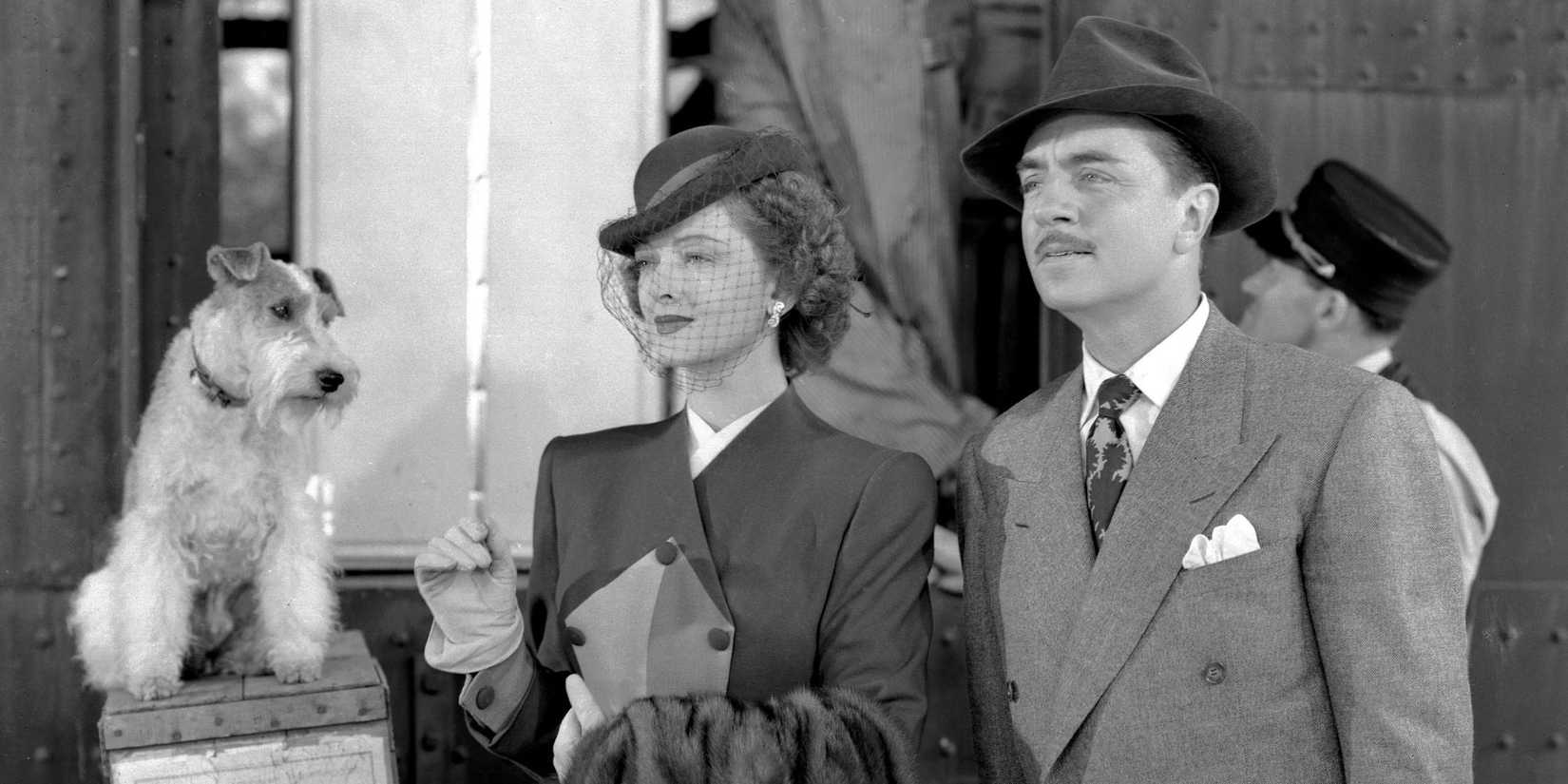 Myrna Loy as Nora, William Powell as Nick, and Skippy as Asta their dog next to them in The Thin Man Goes Home.