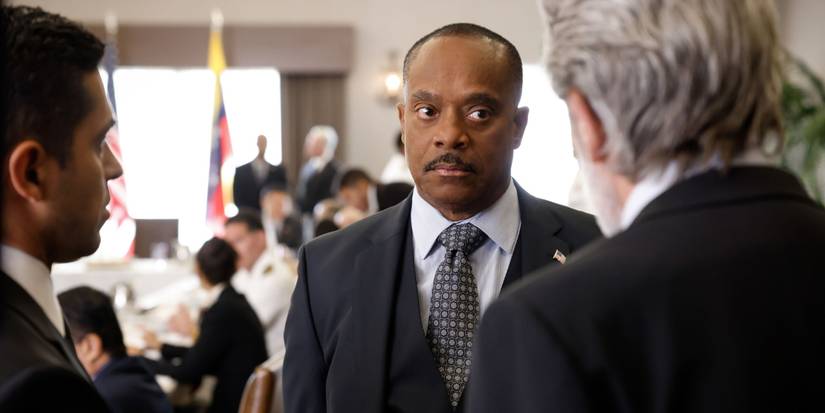 Leon Vance (Rocky Carroll) at a peace conference talking to Alden Parker (Gary Cole) in NCIS