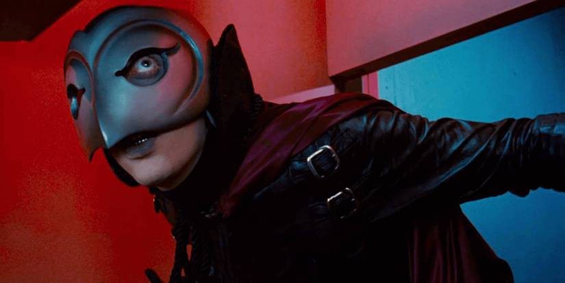 Winslow/the Phantom (William Finley) sneaks into a red room while peering through his helmet in 'Phantom of the Paradise' (1974)