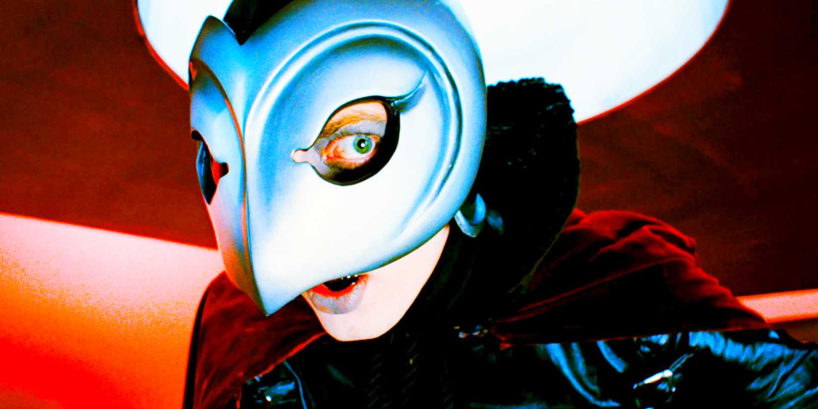Close up of The Phantom, played by actor William Finley, wearing a metallic bird-like mask in Phantom of the Paradise.