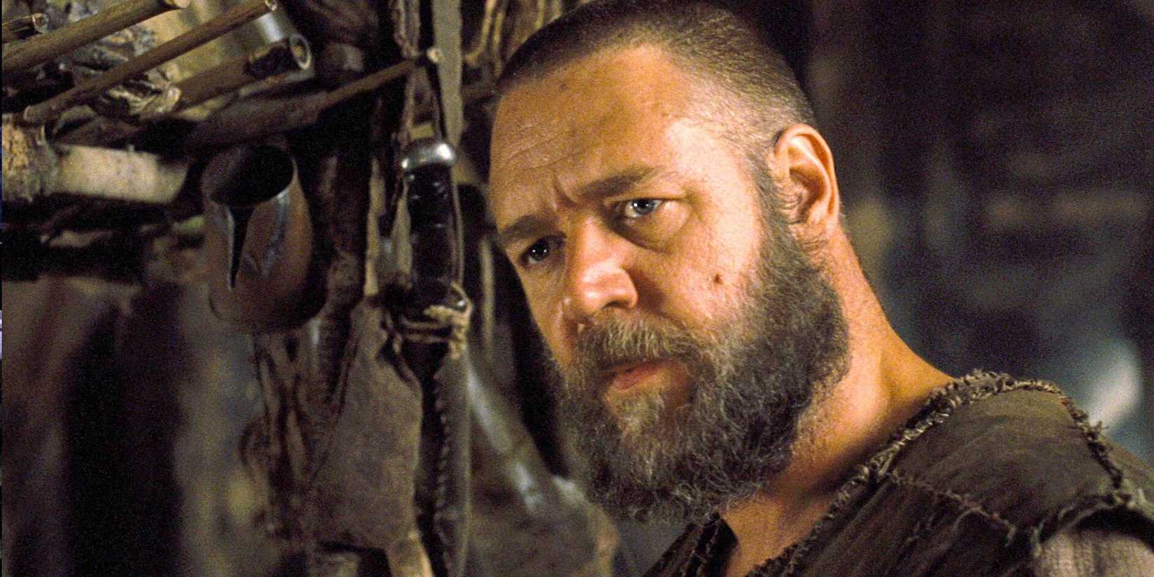 Russell Crowe as Noah looking at someone near tools in Noah (2014)