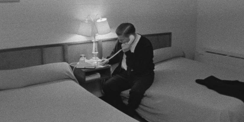 A man talks on a landline phone in a hotel room in Salesman.