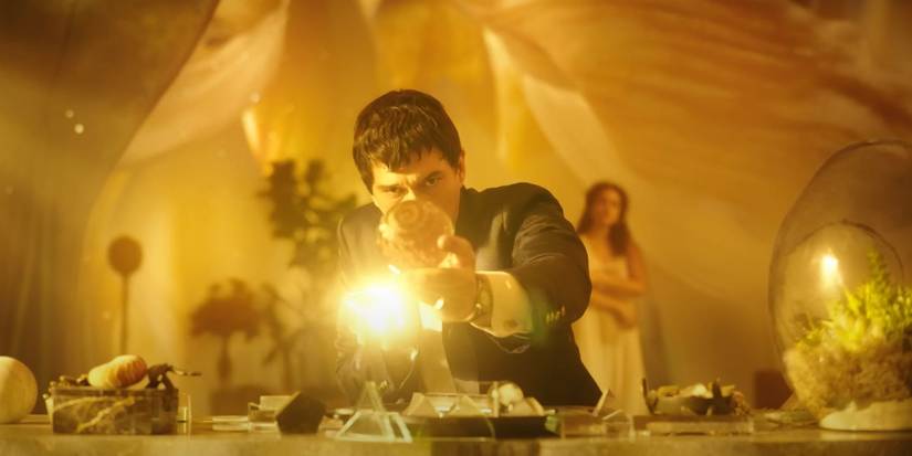 Adam Driver as Cesar revealing a glowing ball inside a vase in Megalopolis (2024).