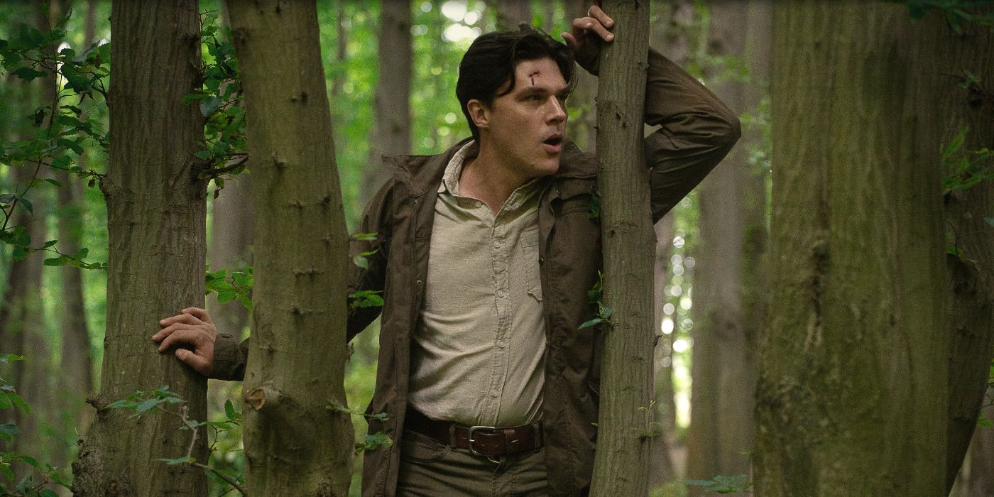 Finn Wittrock as Richard, leaning against a tree with a cut on his forehead in the Netflix thriller Don't Move
