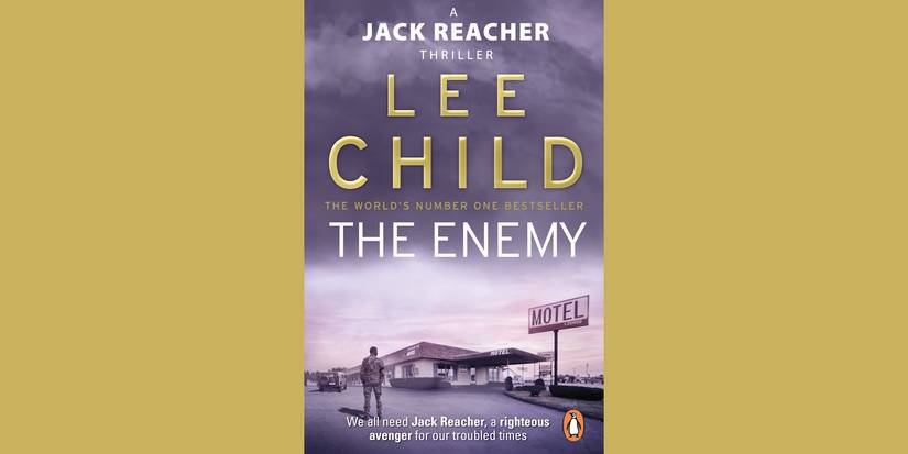 A man stands outside a motel on the book cover of The Enemy by Lee Child.