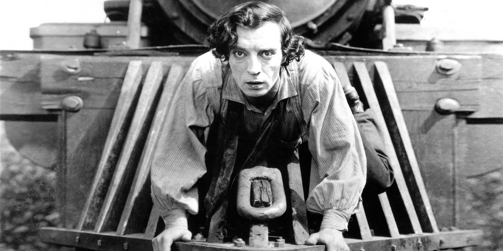 Buster Keaton on the front of a train looking ahead in The General.