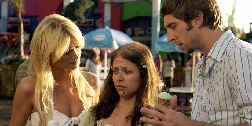 A man and a woman looking at an emotional-looking woman in The Hottie & the Nottie'