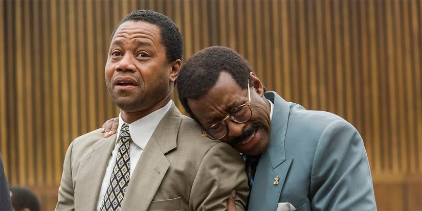 Courtney B. Vance as Johnny Cochran hugging and crying on Cuba Gooding Jr as O.J. Simpson's shoulder in court
