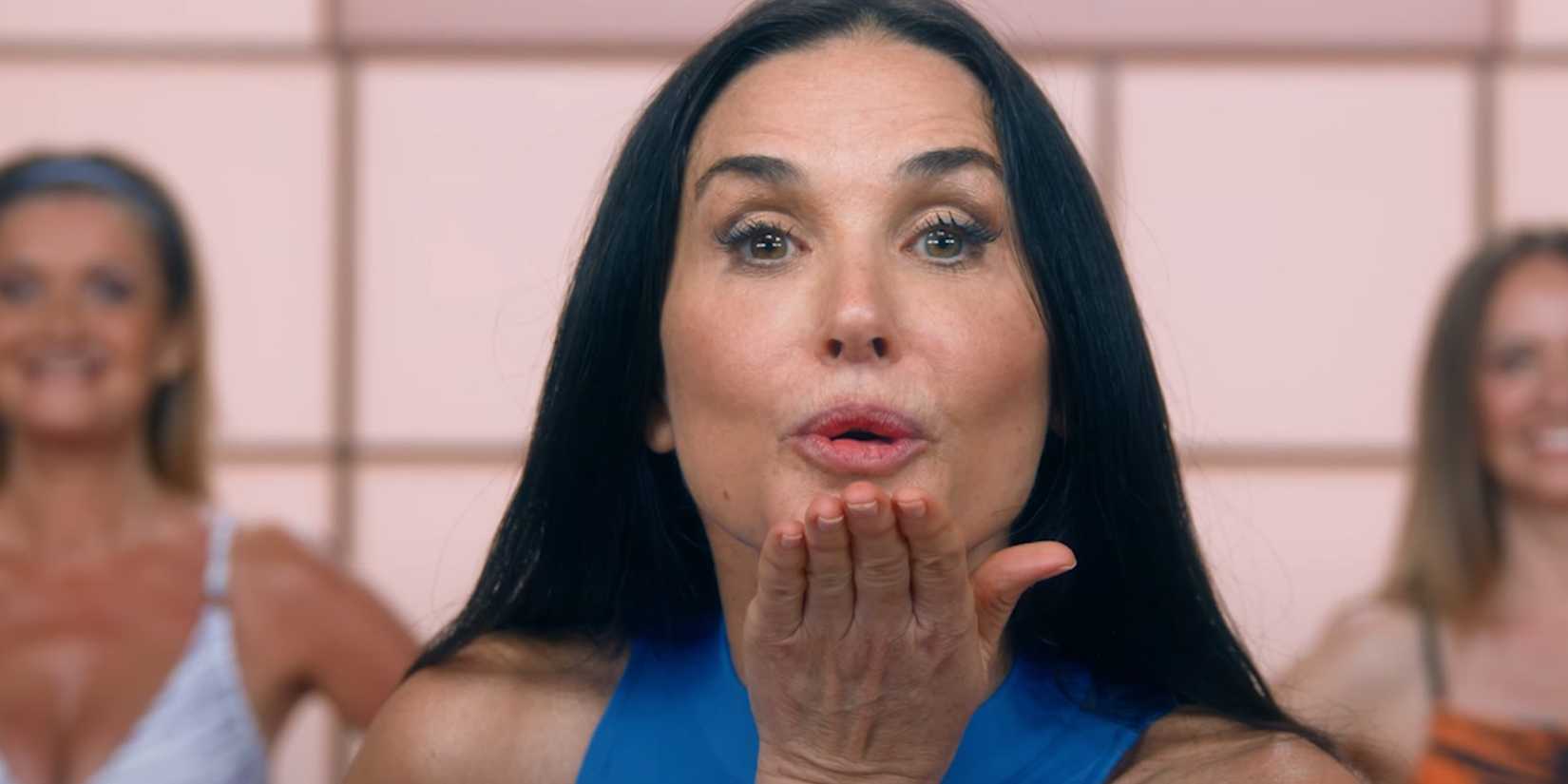 Elisabeth Sparkle, played by actor Demi Moore, blows a kiss at the camera in The Substance.