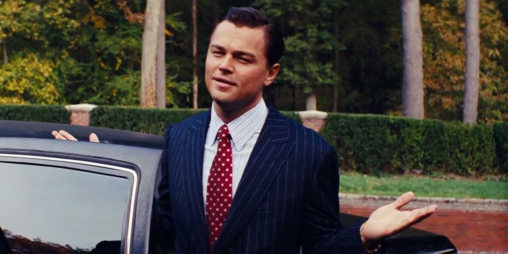 The Wolf of Wall Street - Leonardo DiCaprio in a suit, gesturing as he gets into a car