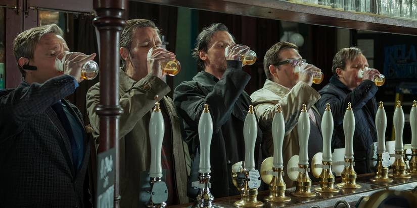 Simong Pegg, Nick Frost, and the rest of the cast drink at a pub in 'The World's End'. 