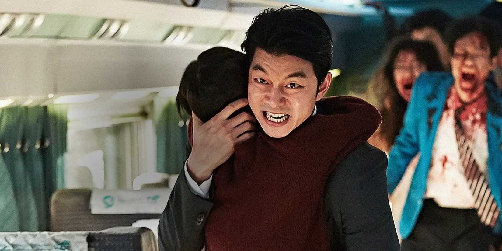 A man carrying a child and running away from zombies in Train to Busan