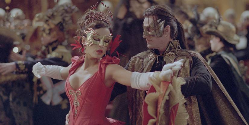 Count Dracula, played by actor Richard Roxburgh, dances with Anna Valerious, played by actor Kate Beckinsale, at a masquerade ball on Halloween night in 'Van Helsing'.