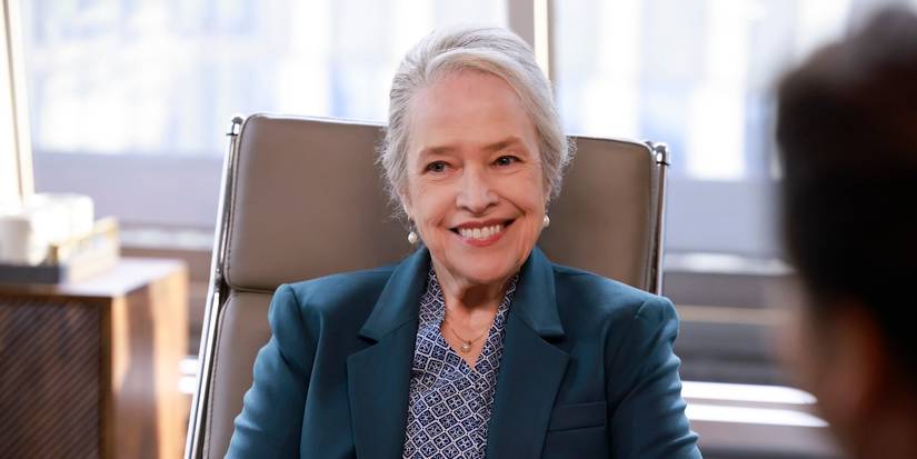Kathy Bates smiling and sitting in an office chair in Matlock Episode 6.