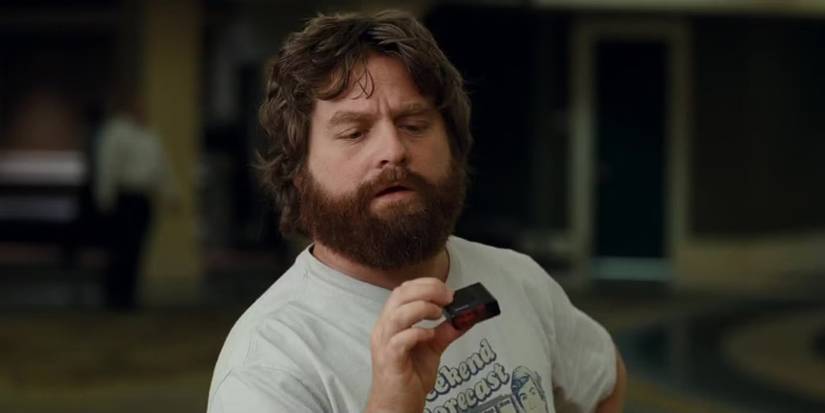 Alan looking at an item in his hands in The Hangover.