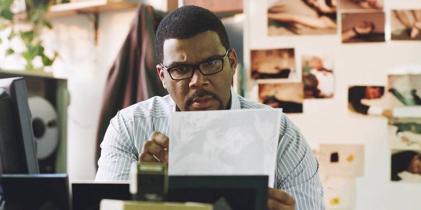 Tyler Perry as Alex Cross looking at a photo in 'Alex Cross'