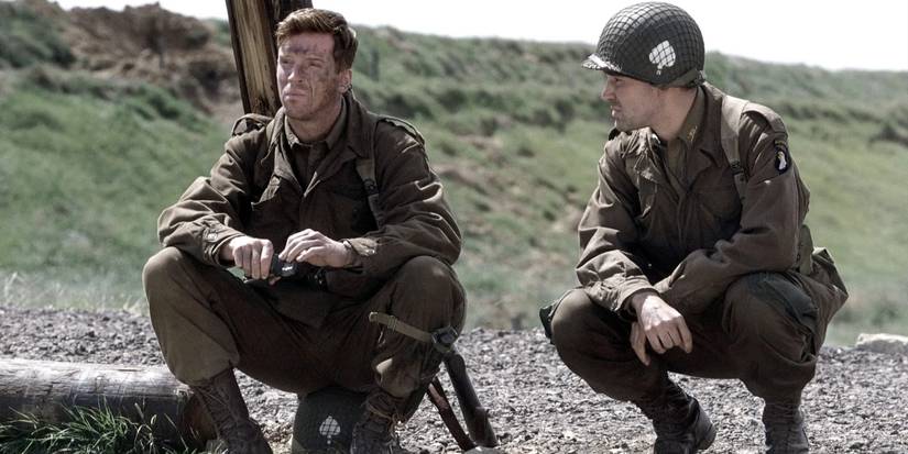 Richard Winters (Damien Lewis) and Lewis Nixon (Ron Livingstone) sit together by a hill in 'Band of Brothers' (2001).