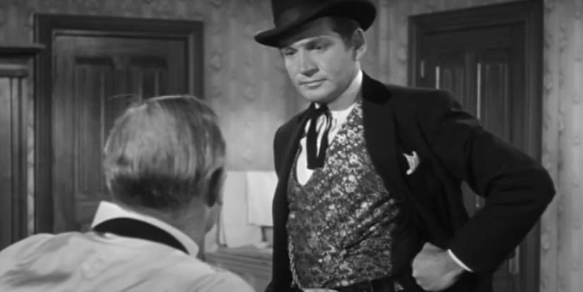 Gene Barry talking with a town member in 'Bat Masterson'