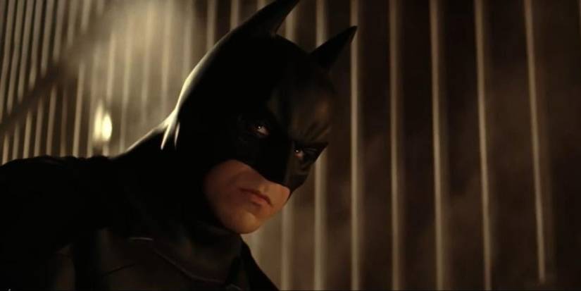 Christian Bale as Batman looking grim in Batman Begins