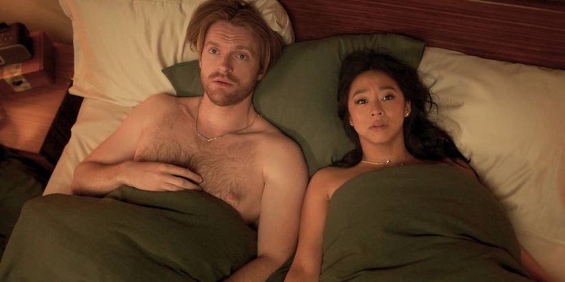 Stephanie Hsu and Finneas O'Connell in bed together, looking up at the ceiling in Laid. 