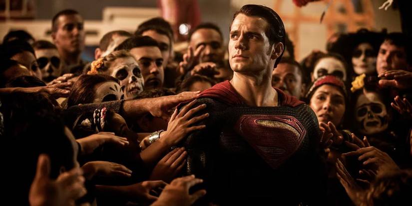 A crowd surrounding and touching Superman in Batman v Superman: Dawn of Justice