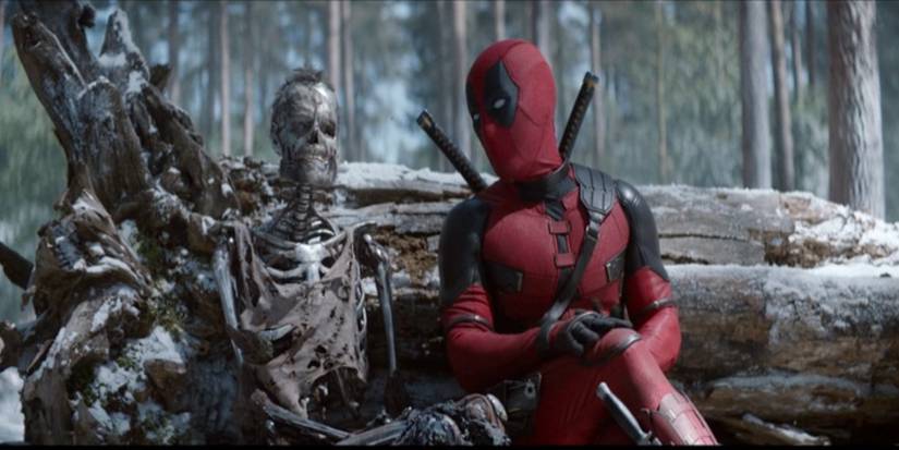 Deadpool sits next to the skeleton of Wolverine in Deadpool & Wolverine.