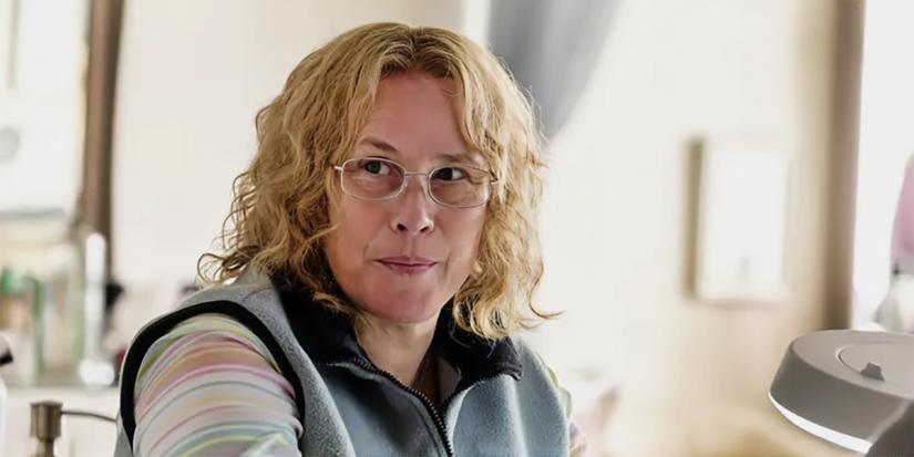 Patricia Arquette wearing clear glasses and looking to the side in Escape from Dannemora.