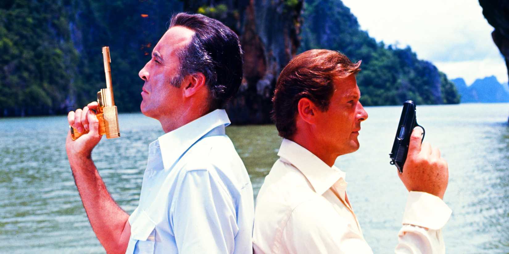 James Bond, played by actor Roger Moore, and Scaramanga, played by actor Christopher Lee, stand back to back with their guns raised in The Man With The Golden Gun.