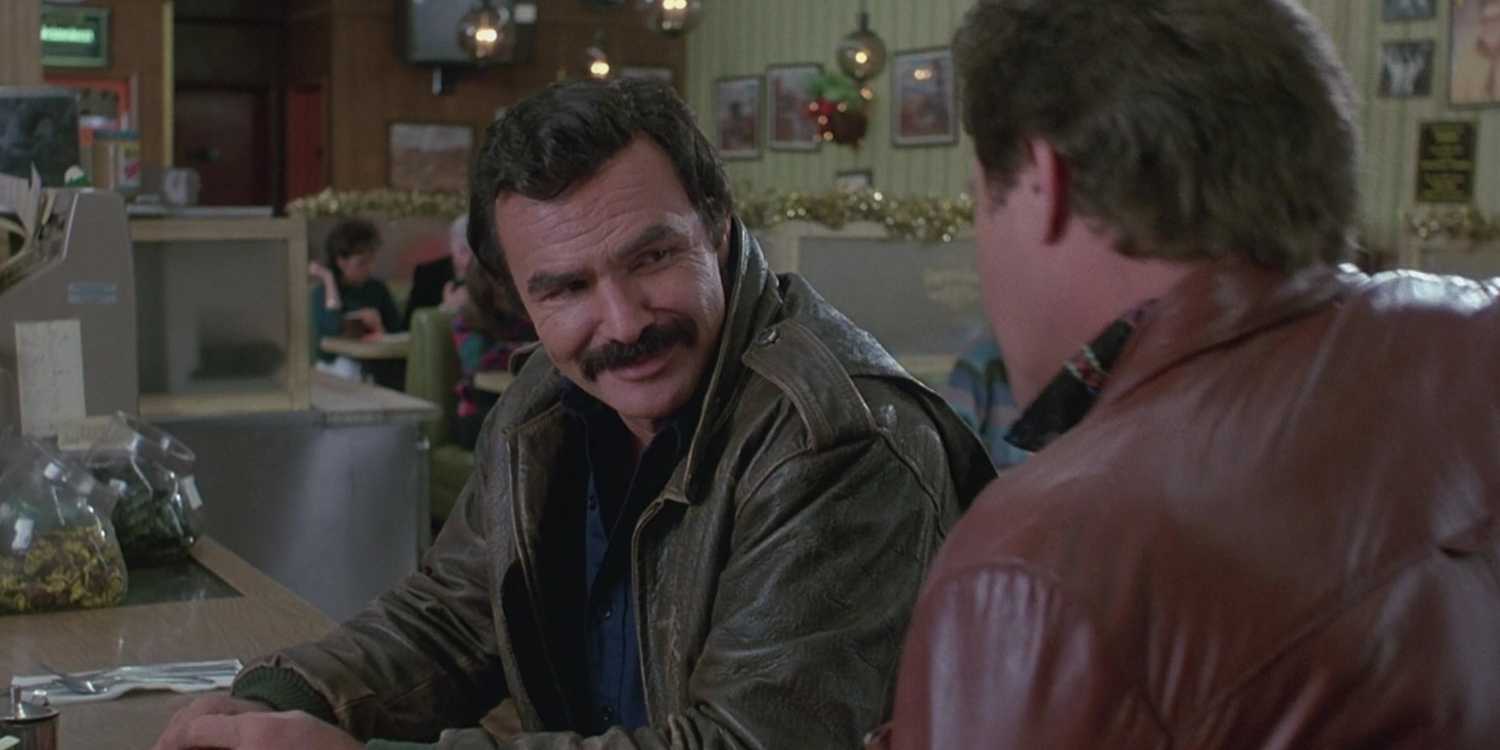 Burt Reynolds as Nick Escalante sitting at a counter in Heat