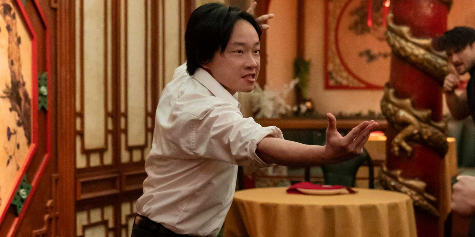 Jimmy O. Yang as Willis Wu getting ready to fight in the Chinese restaurant in Interior Chinatown