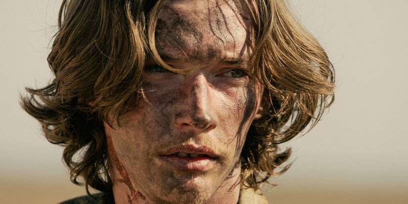 Close-up of Jacob Lofland in Landman covered in dirt and dried blood on his neck.