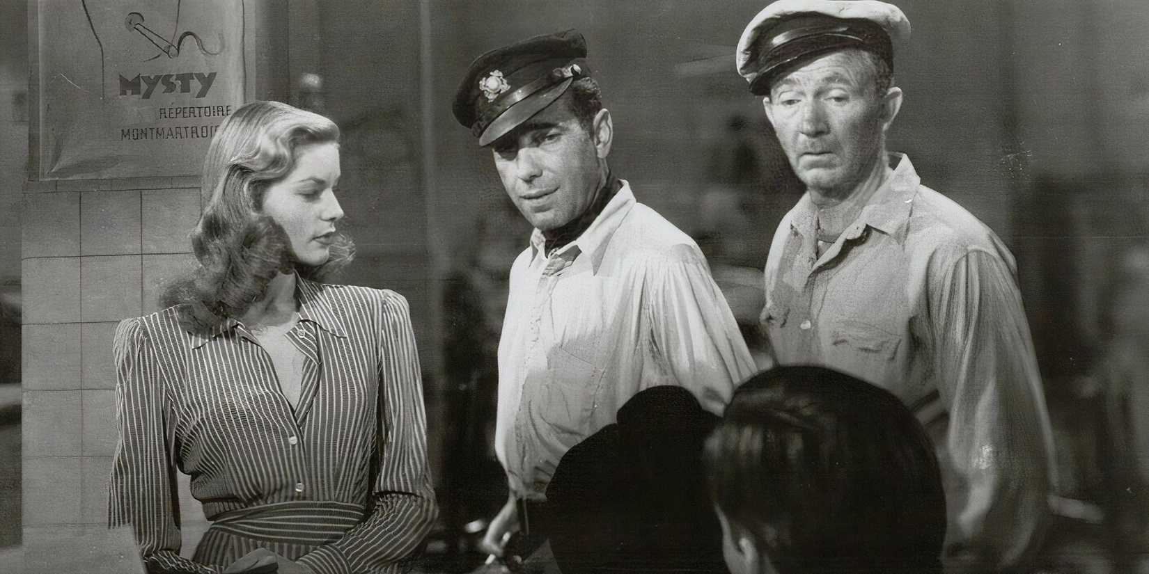 Lauren Bacall as Slim, Humphrey Bogart as Steve, and Walter Brennan as Eddie in To Have and Have Not all standing next to each other.
