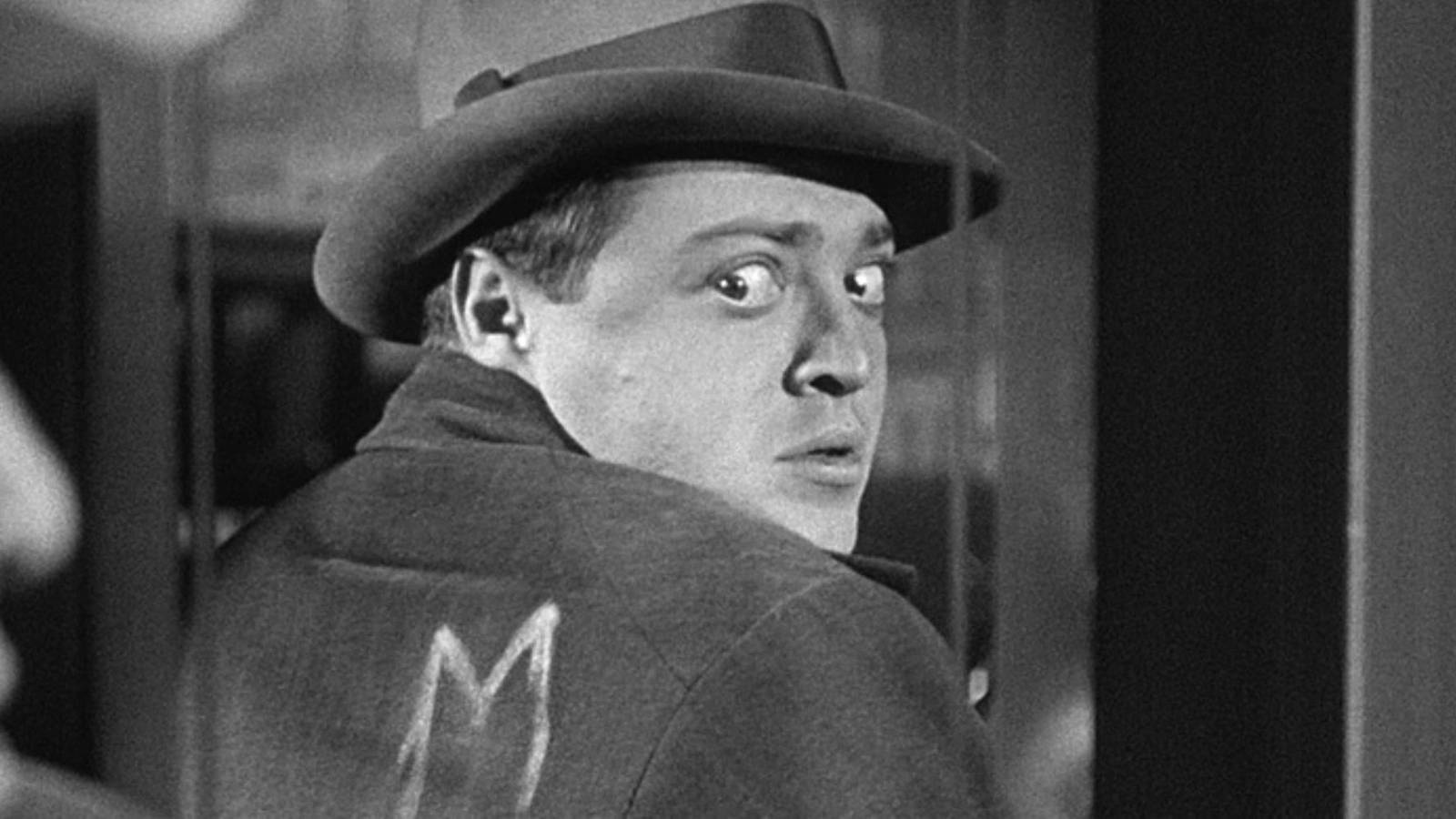 Peter Lorre looking back at his reflection in a window in 'M' (1931)