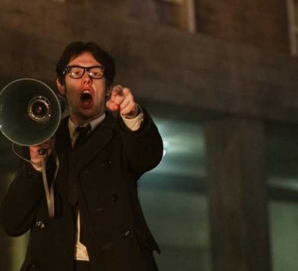 Josh Finan as Gerry Adams holding a megaphone speaker while screaming in 'Say Nothing'