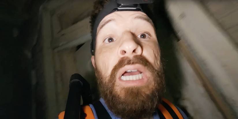 Joseph Winter as Shawn Ruddy on a livestream, vlogging in a dark place with a headcam in Deadstream.