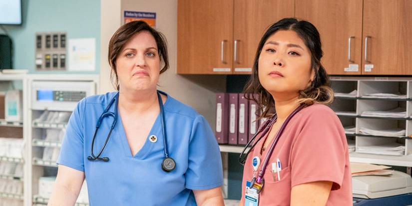 Allison Tolman as Alex, Kahyun Kim as Serena at a nurses' station looking unamused in St. Denis Medical.