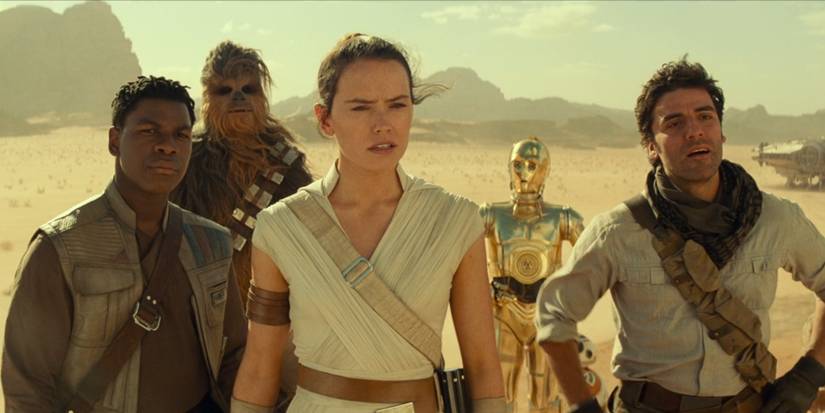 Finn, Chewbacca, Rey, C-3PO and Poe all look onward on a sandy planet in 'Star Wars: The Rise of Skywalker'.