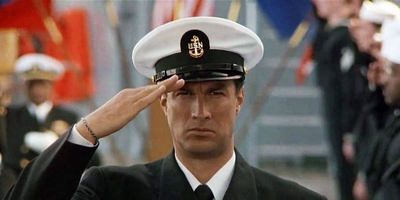 Steven Seagal wears a military dress uniform and salutes in Under Siege.